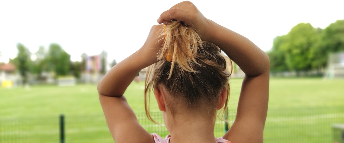 Girl tying her hair
